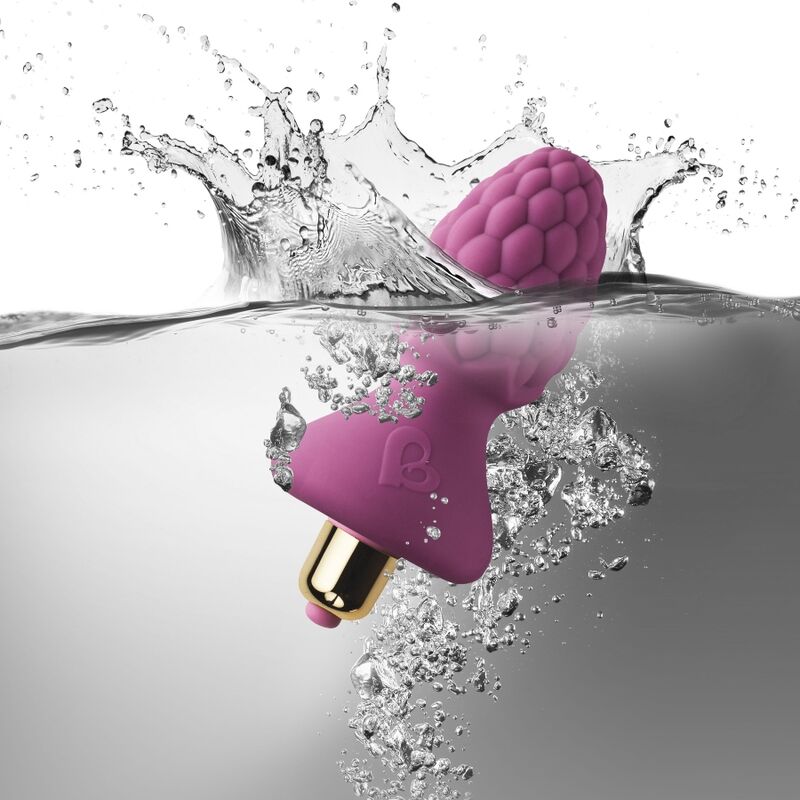 Plug anal framboise rose plongeant dans l'eau avec éclaboussures, tête texturée et base en T visibles, démontrant l'étanchéité du jouet anal en silicone rose.