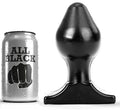 Plug anal All Black silicone large a profil de toupie, place pres de sa canette de presentation, corps bombe et socle evase pour une sensation de remplissage marquee mais souple.