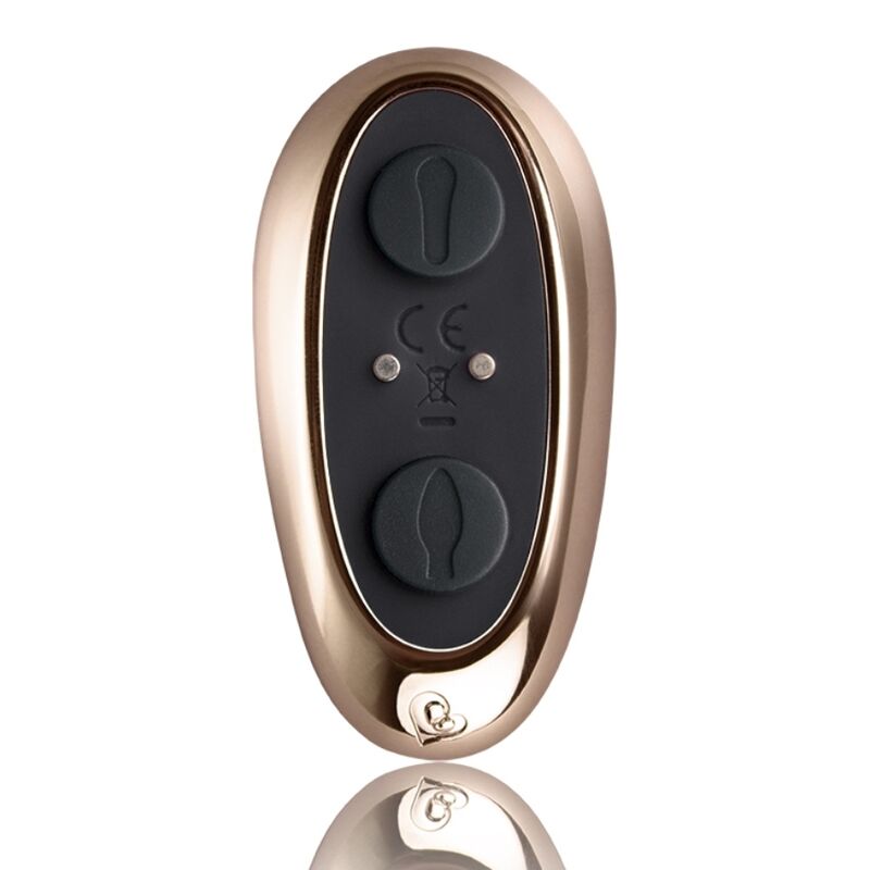 Vue de face de la télécommande ovale dorée du Cocktail, deux grandes molettes de réglage et bouton central, accessoire lisse sans aucun visuel anatomique.