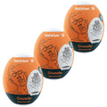 Trois oeufs masturbateurs Satisfyer Crunchy orange empiles, gaines blanches a texture geometrique, motifs de visages au trait sur chaque coque.