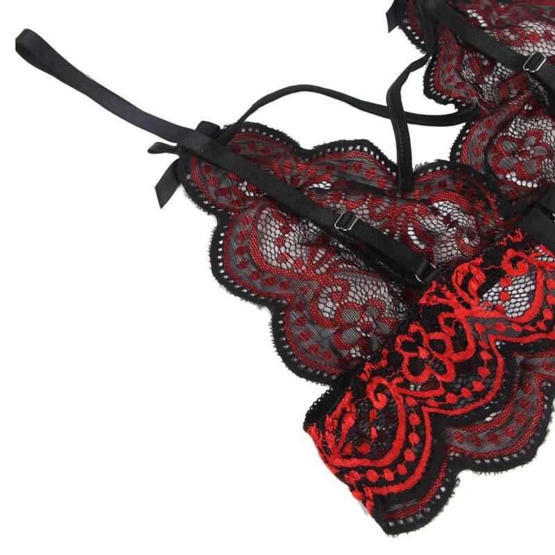 Gros plan sur la bralette Subblime en dentelle rouge et noire a plat, nœud satin, bretelles croisees et broderie florale ajouree detaillee.