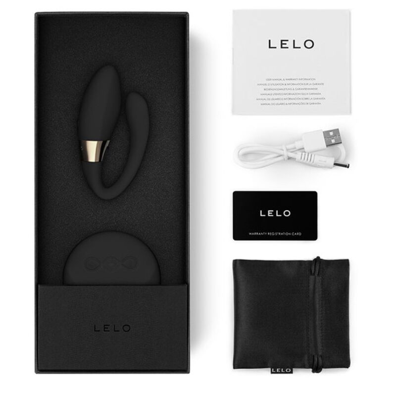 Stimulateur de couple Tiani Duo de Lelo noir dans son écrin avec le manuel, le câble USB, la carte de garantie et la pochette satinée de rangement noire.