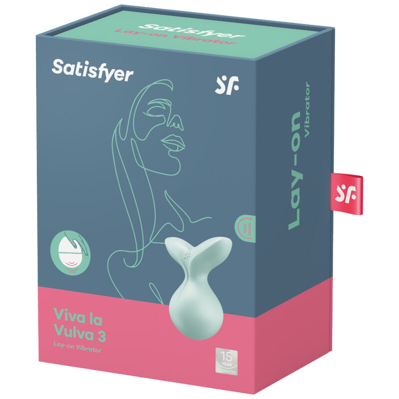 Boite du vibromasseur clitoridien a poser Viva La Vulva 3 Satisfyer en silicone etanche, illustree d'un visage graphique, embout vert lay-on visible sur le packaging.