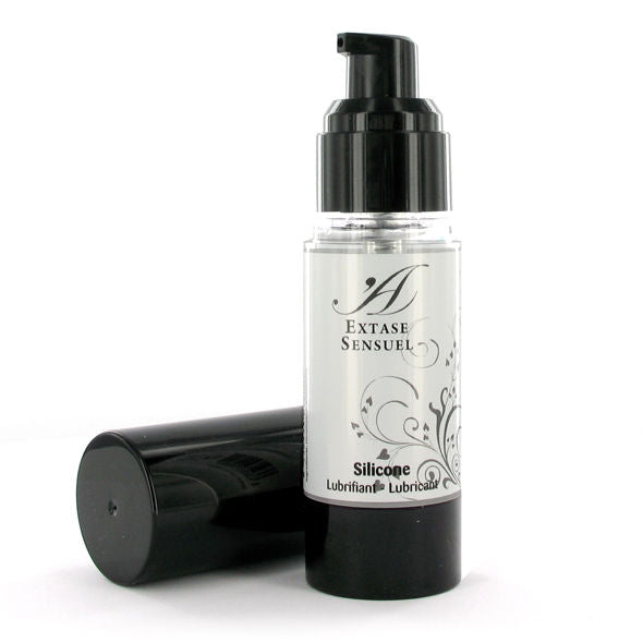 Flacon airless Extase Sensual de lubrifiant silicone 30 ml debout, capuchon noir pose a cote, glisse ultra-soyeuse longue duree resistante a l'eau pour un usage unisexe.