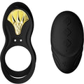 Cockring Bayek noir à anneau simple et plastron doré présenté avec sa télécommande galet noire, accessoire de couple en silicone lisse, sans anatomie.