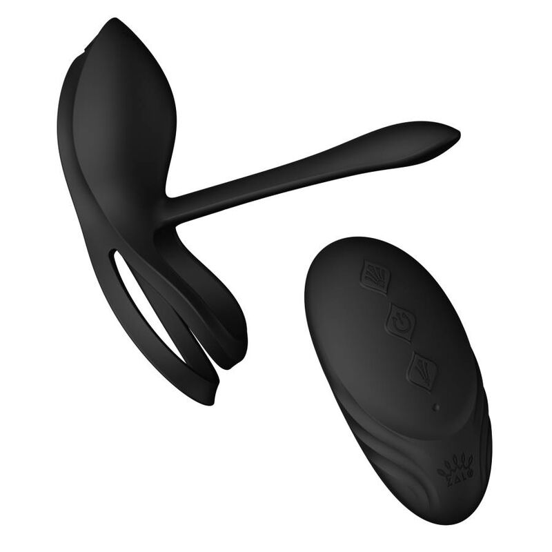 Cockring Bayek noir à double anneau et bras extensible posé près de sa télécommande galet noire, ensemble pour couple en silicone lisse, sans anatomie.