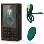 Boîte Bayek noire et dorée à félins égyptiens présentée avec le cockring vert et sa télécommande galet verte posés à côté, ensemble de couple complet.
