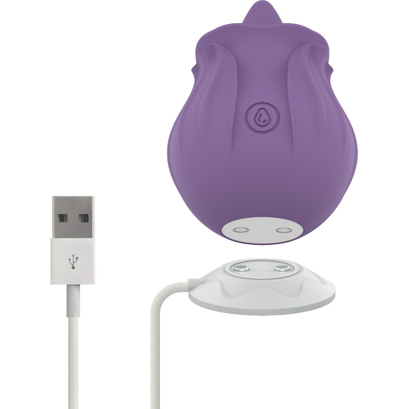 Stimulateur clitoridien Violet en forme de rose pose sur sa base de charge magnetique et son cable USB ; sextoy en silicone a langue mobile, plusieurs modes, design floral Intense