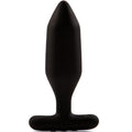 Plug anal Onyx noir en silicone présenté debout, corps facetté à pointe nette et large base évasée, finition mate inspirée de la pierre, vue verticale du produit sur fond blanc.