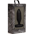 Boîte Je Joue grise présentant le plug Onyx noir facetté derrière la fenêtre transparente, fond de plume sombre et mention strong hexagonal shaped butt plug imprimée en bas.