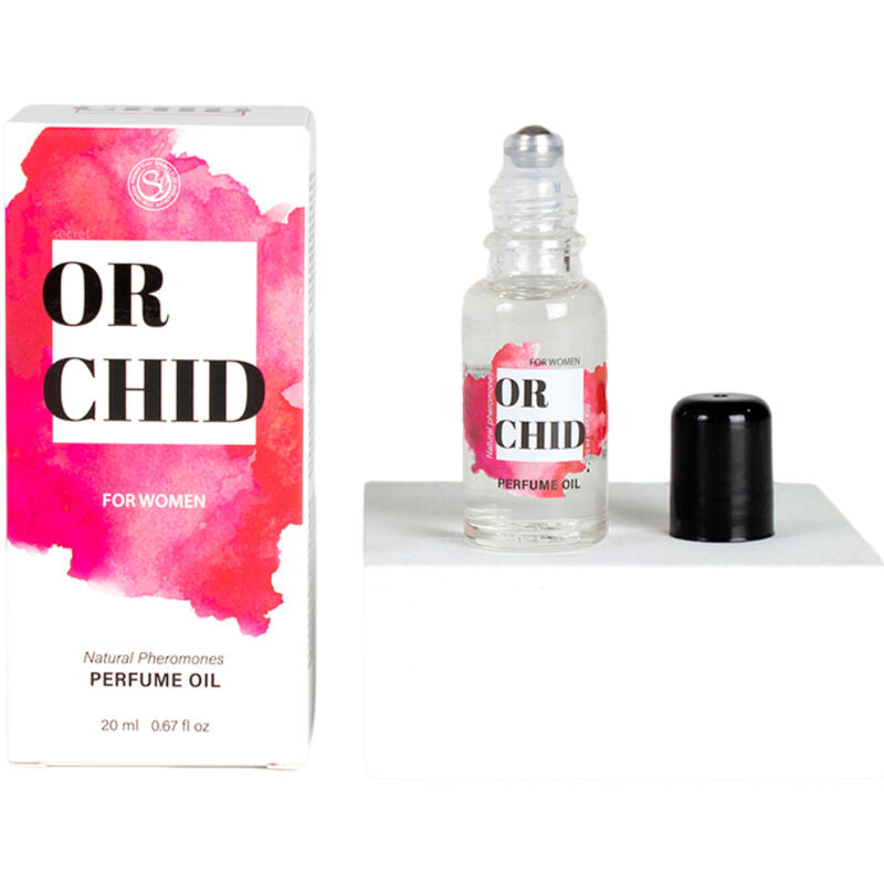 Flacon roll-on d'huile aux pheromones Orchid bouchon ote, pose pres de sa boite rose. Format 20 ml nomade, deux applications suffisent pour une fragrance vanille orchidee.
