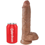 Gode realiste King Cock a testicules dresse a coté d'une canette Pipedream rouge pour l'echelle de taille, gland bombe et veines saillantes, base ventouse, teinte caramel effet peau.