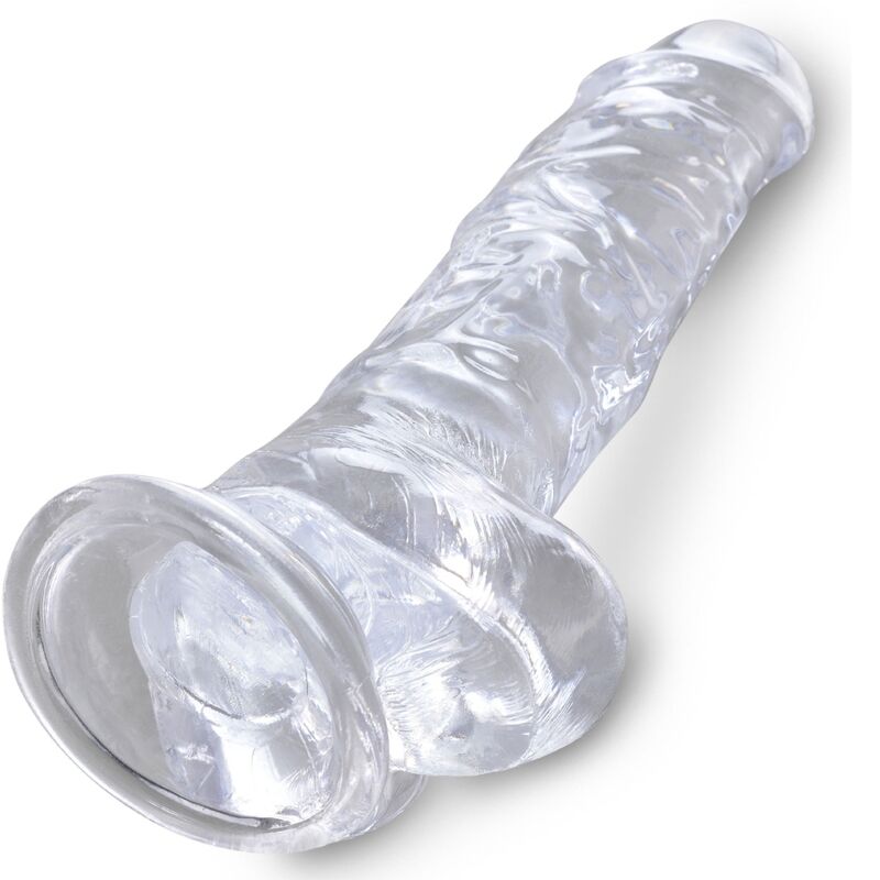 Gode realiste en gelee cristal couche de trois quarts, tige veinee et gland prononce, base ventouse claire compatible harnais, modele King Cock Clear.