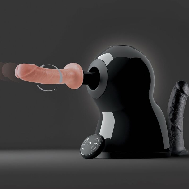 Machine de sexe The Bigger Bang presentee avec deux godes realistes interchangeables, chair et noir, montes sur l'axe motorise rotatif.