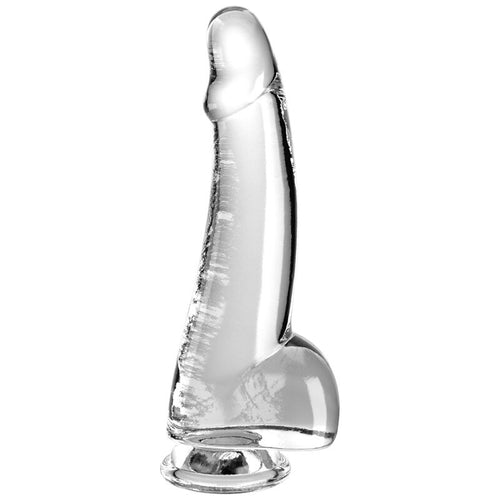 Gode King Cock Clear transparent avec gland marqué et testicules moulés, base ventouse large, vue de trois quarts révélant les reliefs réalistes.