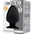Packaging SILEXD du plug anal Modèle 1 taille M, boîte Premium Silicone Plug grise avec visuel du plug noir lisse double densité et mentions thermoréactif