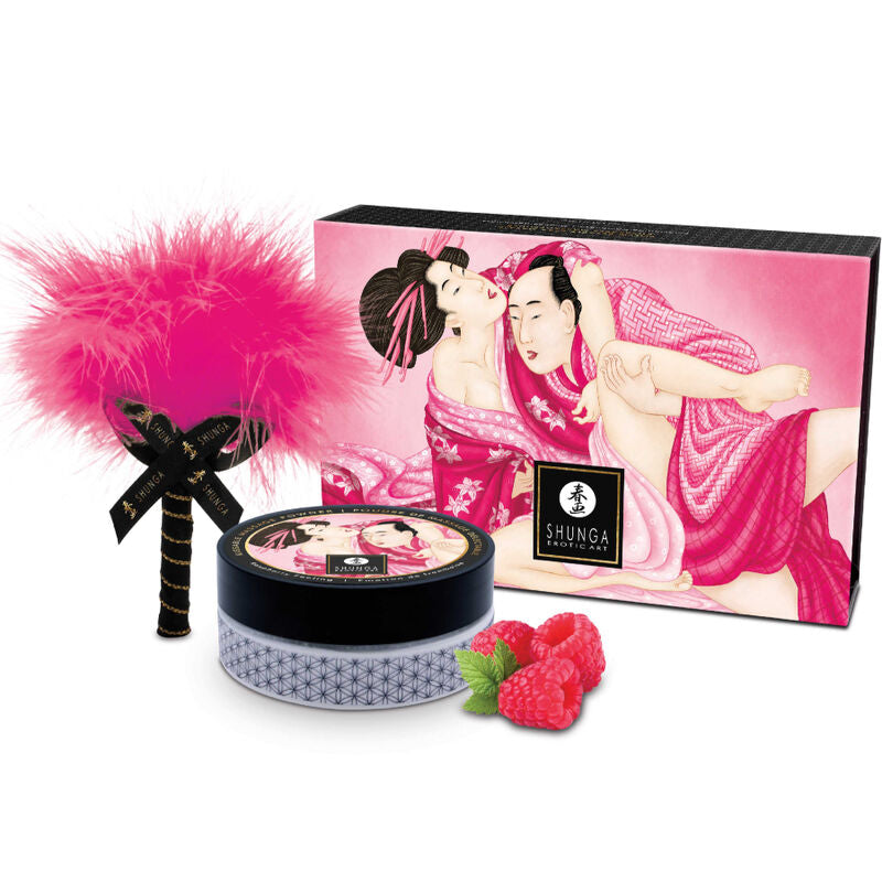 Sels de bain Shunga Lovebath dans leur boitier rond, accompagnes d'un pinceau plume rose et d'une boite illustree d'un couple enlace, perles transformables en gel hydratant.