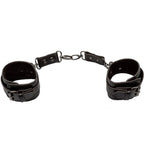 Manchettes de cheville Euphoria noires posées à plat, reliées par une chaîne centrale à trois maillons rivetés.