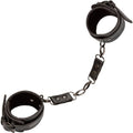 Manchettes de cheville Euphoria noires reliées par une chaîne à mousquetons pivotants, sangles ouvertes à plat sur fond blanc.