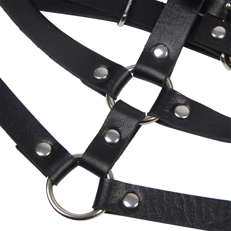 Gros plan sur le jeu de sangles en cuir noir, boutons pression et anneau du harnais de poitrine Subblime, structure fetichiste graphique taille unique.