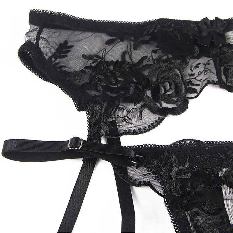 Detail a plat du porte-jarretelles noir Subblime : dentelle florale a roses, brides reglables a boucles et bande dentelle, presentation produit.