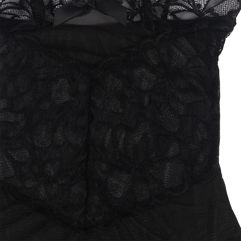 Gros plan sur la dentelle florale noire du babydoll Subblime, tissu transparent travaille en motifs fleuris, posee a plat sans modele pour reveler la finesse de la maille.