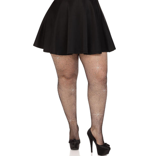 Jambes en collants resille noirs a details scintillants, portes sous une jupe patineuse noire avec escarpins, taille unique, ambiance soiree sensuelle.