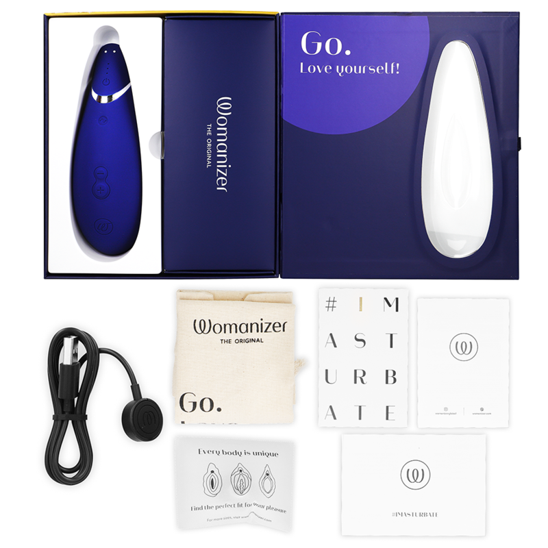 Coffret bleu nuit ouvert du Womanizer Premium 2, câble de charge, sachet et cartes de notice à plat, stimulateur clitoridien bleu rechargeable par ondes d'air.