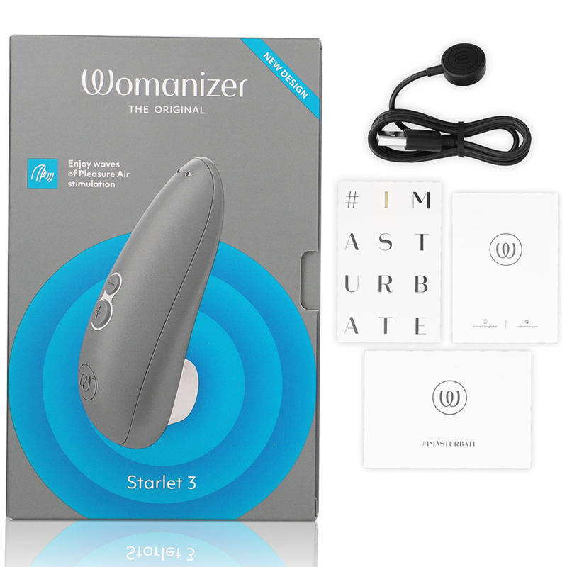 Boîte grise et bleue du Starlet 3, câble de charge et cartes de notice à côté, stimulateur clitoridien Womanizer gris par aspiration d'air. Présentation complète du coffret cadeau.