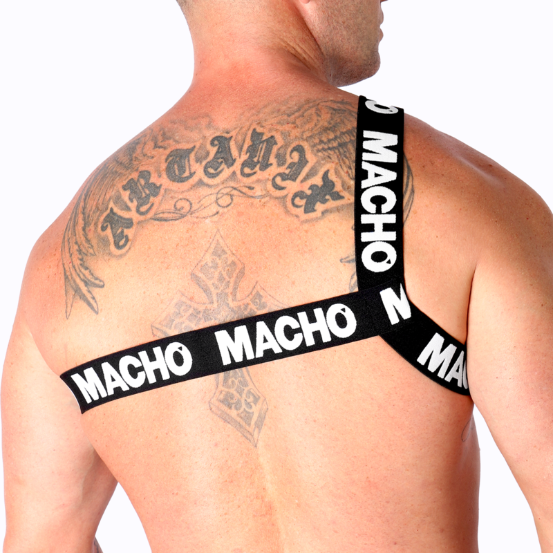 Harnais homme Macho à sangles jaunes vu de dos sur dos très tatoué musclé, bandes logo croisées entre les omoplates, soulignant un style fétichiste structurant près du corps.