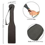 Paddle en cuir noir avec dragonne — détail texture surface
