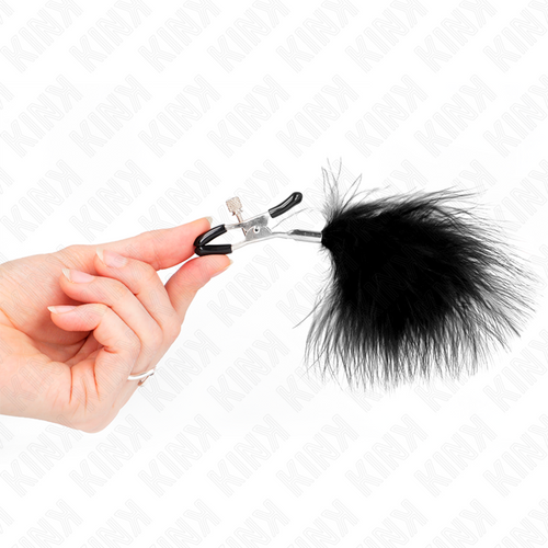 Pince à tétons à plumeau de plumes noires tenue par la main, gros plan sur le mécanisme de serrage réglable de l'accessoire sensuel.
