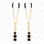 Pinces a tetons fines dorees a billes de verre noir, presentees verticalement sur fond blanc. Accessoire BDSM de 7 cm au pincement leger et reglable pour stimulation.
