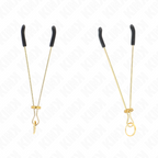 Paire de pinces a tetons fines dorees a embouts caoutchouc noir, profil elance de 7 cm presente a plat pour une stimulation nette et ciblee.