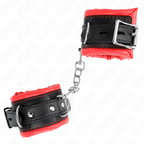 Manchette de poignet noire doublee de rouge a boucle metallique et chaine, vue rapprochee du contraste bicolore de cet accessoire de soumission.