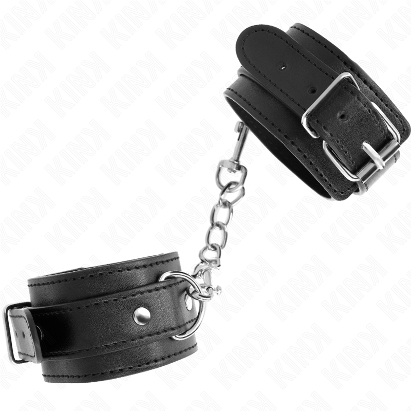 Paire de menottes en cuir noir à boucle ardillon reliées par une chaîne, présentées à la verticale, kit d'attache de bondage pour jeux de soumission