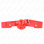 Baillon boule rouge ajourée sur fine sangle rouge a boucle metallique, vue de cote. Ball gag respirant colore pour les jeux de domination a deux.