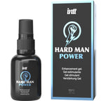 Flacon spray noir Intt Hard Man Power a cote de sa boite bleue, gel stimulant masculin sensations intenses au design poing graphique, format 15 ml