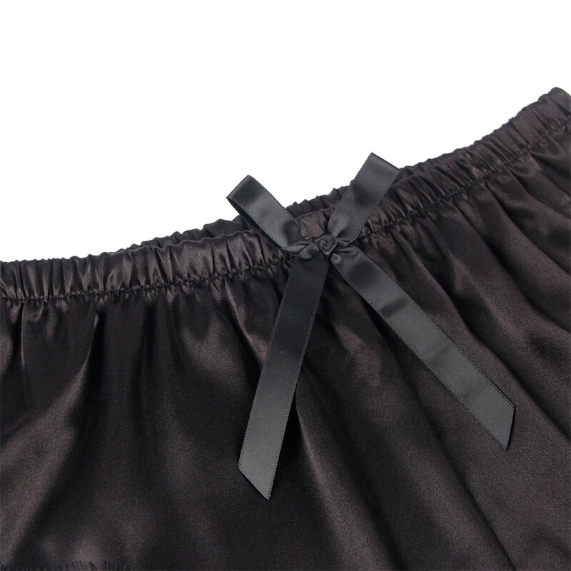 Detail du noeud satin et de la ceinture elastiquee du short noir Subblime, gros plan sur le tissu satine brillant de la parure deux pieces.