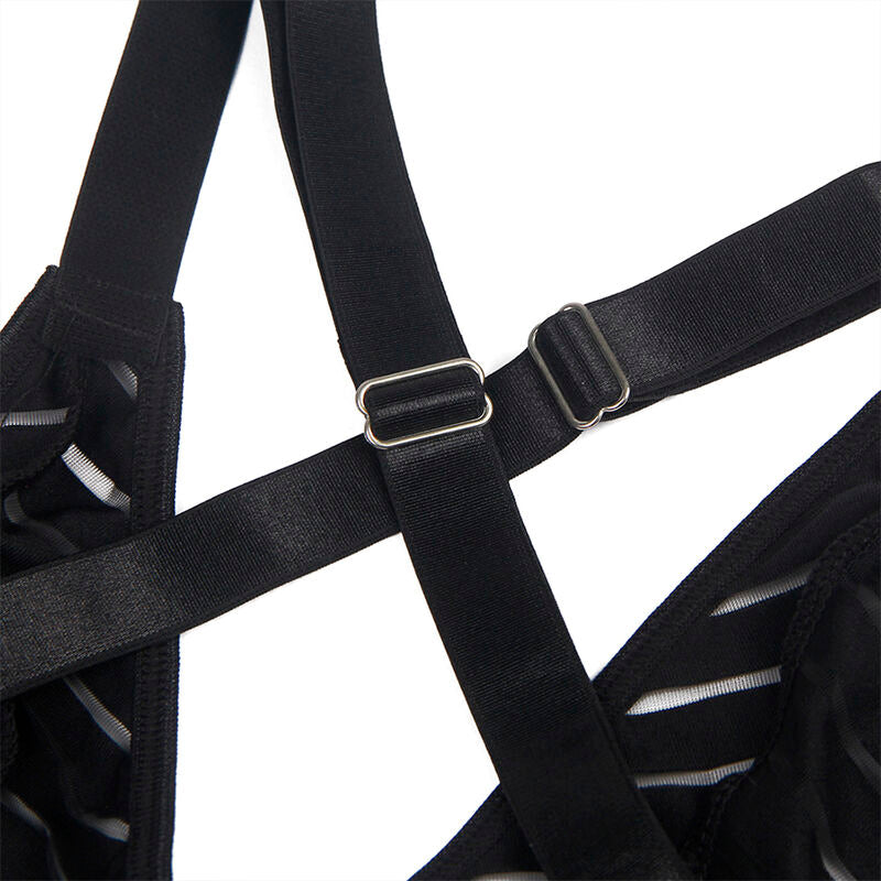 Gros plan sur les bretelles croisees noires et boucle de reglage du body Subblime, finition elastique laissant entrevoir la maille rayee transparente.