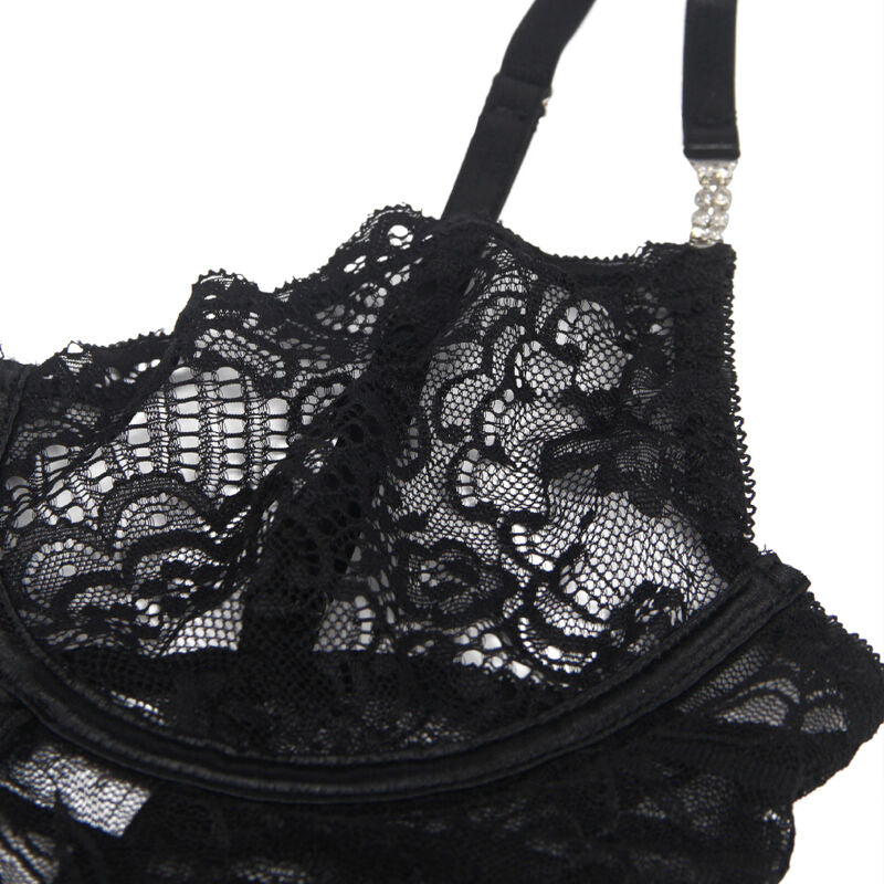 Detail rapproche du bonnet a armature du babydoll Subblime, dentelle florale noire et bordure festonnee, bretelle reglable a embout strass scintillant.
