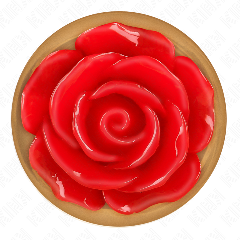 Gros plan du socle floral d'un plug anal or rose, large rose rouge sculptee en relief sur base doree ronde, detail decoratif du grand bijou anal