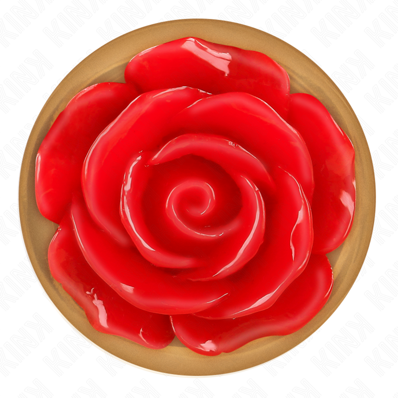 Gros plan du socle floral d'un plug anal or rose, rose rouge en relief sur base doree ronde, detail decoratif vu de dessus du bijou anal