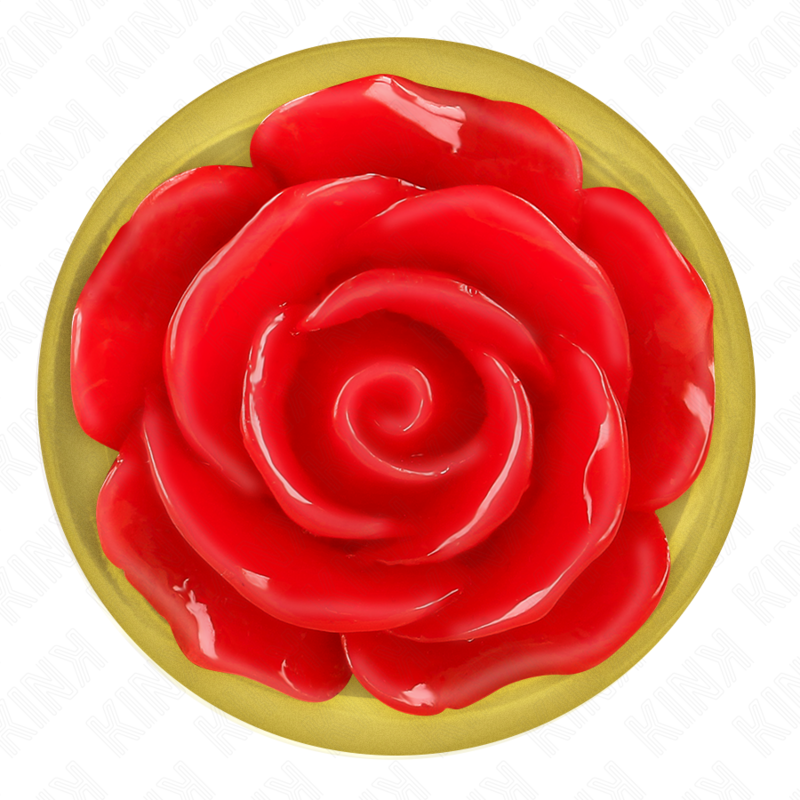 Gros plan du socle floral dore d'un plug anal, rose rouge en relief sur base ronde brillante, detail decoratif vu de dessus du bijou anal