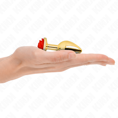 Plug anal dore a rose rouge pose dans la paume d'une main, echelle compacte du bijou anal en acier et finition brillante de l'embout effile
