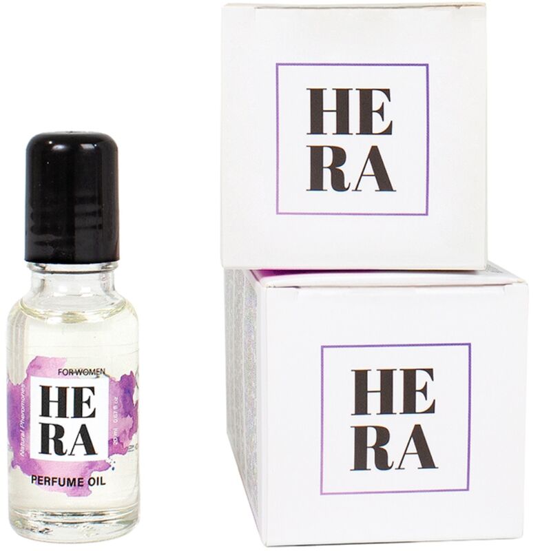 Flacon roll-on Hera For Women aux pheromones devant ses boites blanches empilees, huile de parfum feminine 20 ml Secret Play a bille pour application sur la peau.