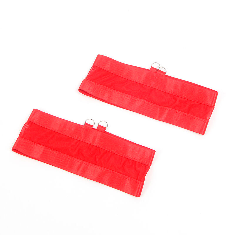 Gros plan sur les deux bandes satinees rouges avec anneaux metalliques de l'ensemble Subblime, detail de finition sur fond blanc.