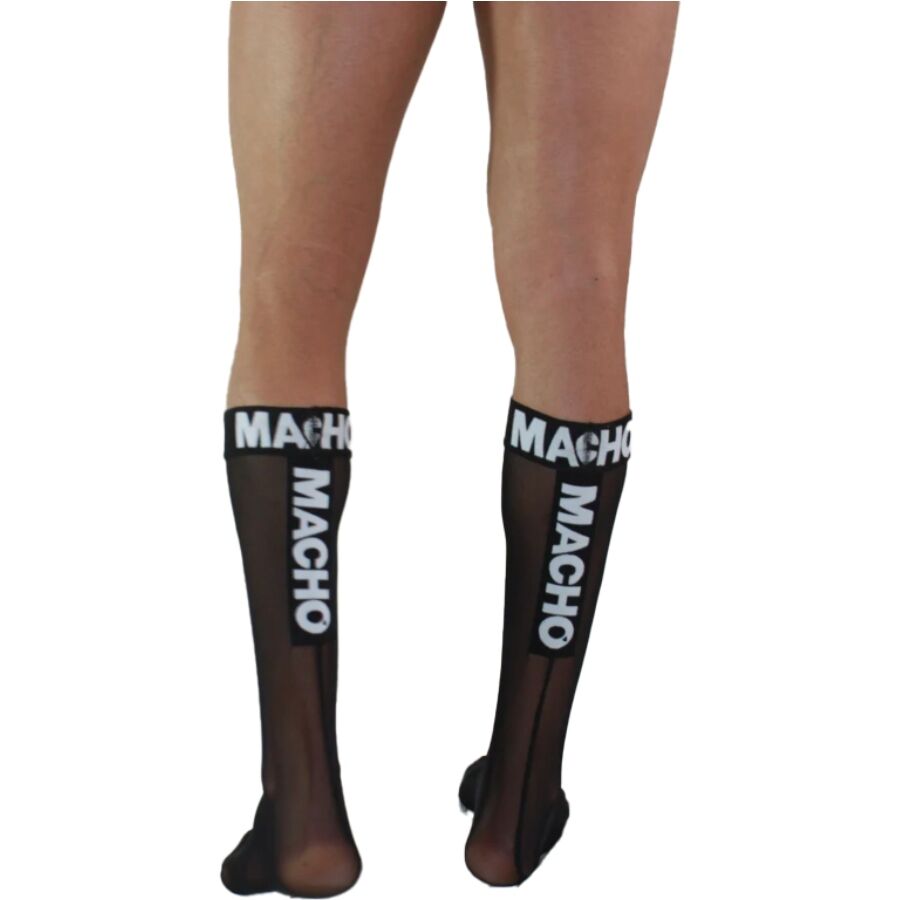 Chaussettes hautes homme noires semi-transparentes vues de dos, logo Macho blanc vertical, maille polyester fine fetichiste soulignant le mollet.