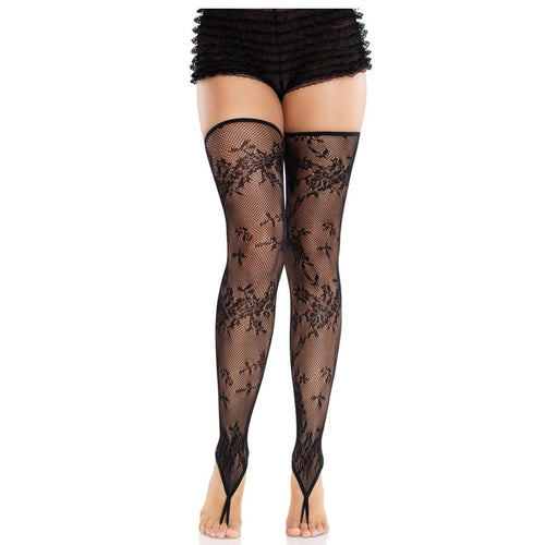 Bas resille noirs a motif floral portes sous un short volante, maillage dentelle delicat et couture arriere, jambes fines vers chevilles nues.