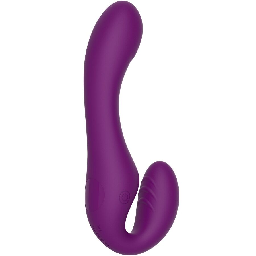 Strap-on sans harnais en silicone violet presente de face, tige interne lisse et branche externe courbe, vibrations et pulsations a trois moteurs pour le couple.